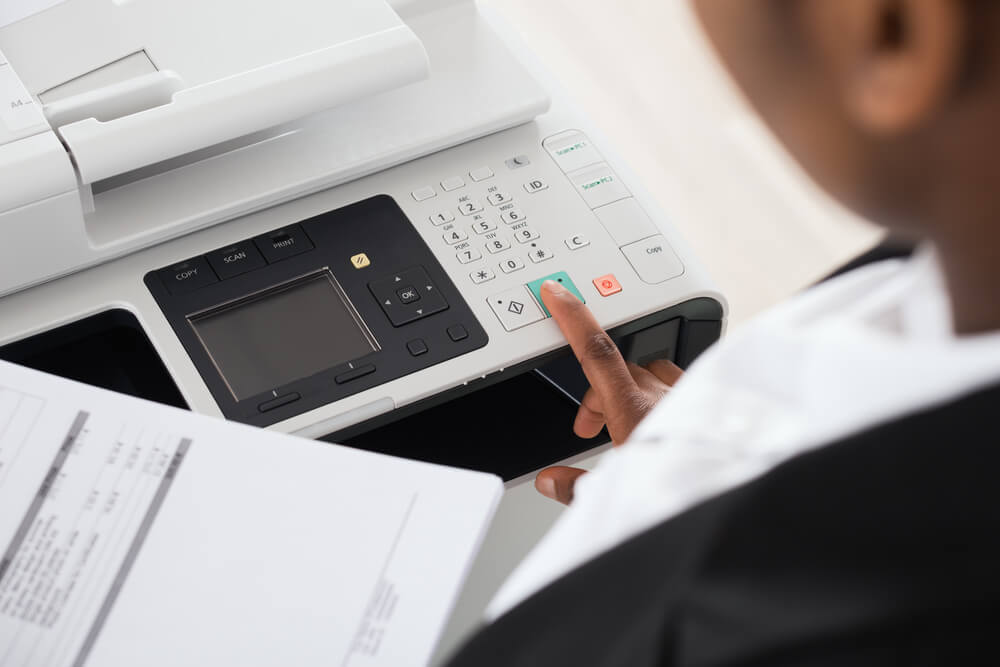 Businesswoman using a printer