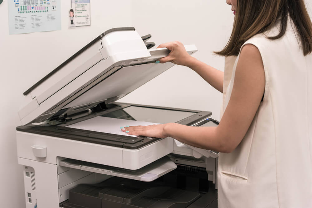 Businesswoman Put Documents on Printer for Scanning and Copying in Office