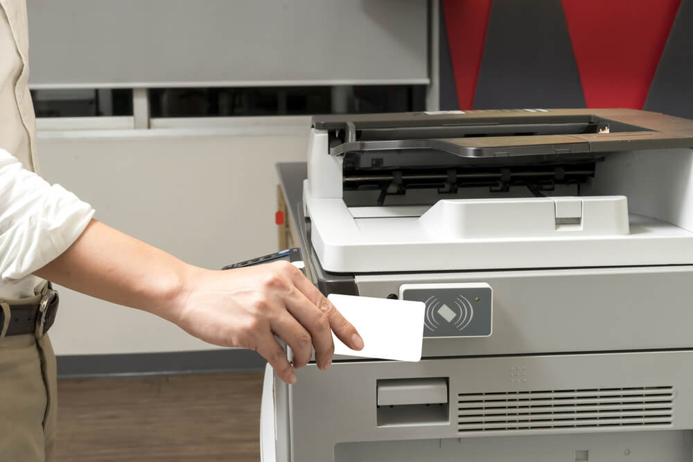 Man Hand Hold Card for Scanning Key Card to Access Photocopier