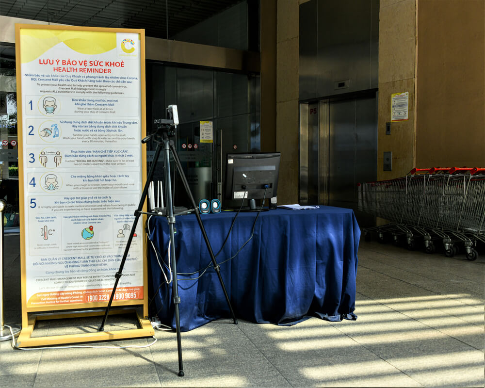 Temperature Check Kiosk With Thermal Camera and Regulation Sign in Front of Supermarket During covid19