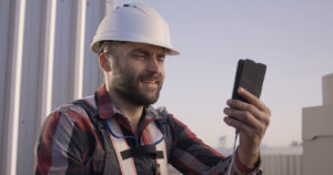 Medium Shot of a Face Mask Wearing Engineer Having a Video Call
