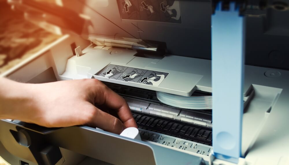 A Man Is Repairing a Printer