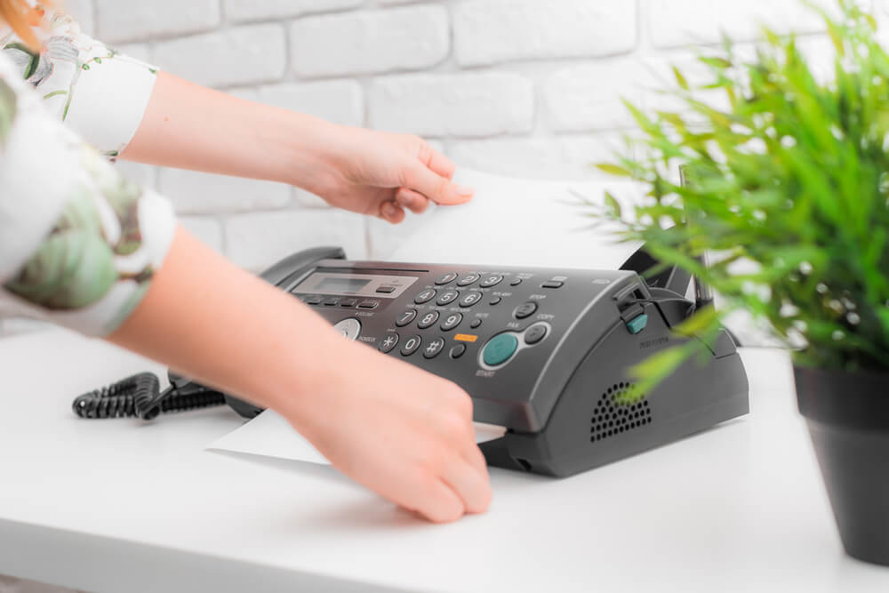 Woman’s Hands Using Fax