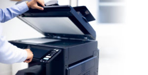 Bussiness Man Hand Press Button on Panel of Printer