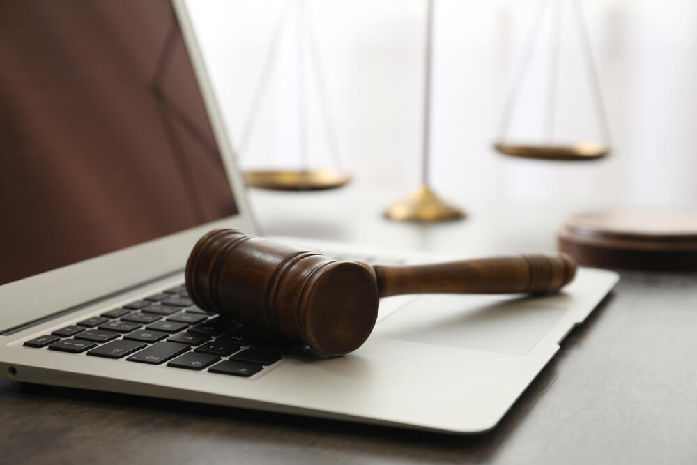 Laptop, Gavel and Scales on Table, Closeup. Cyber Crime