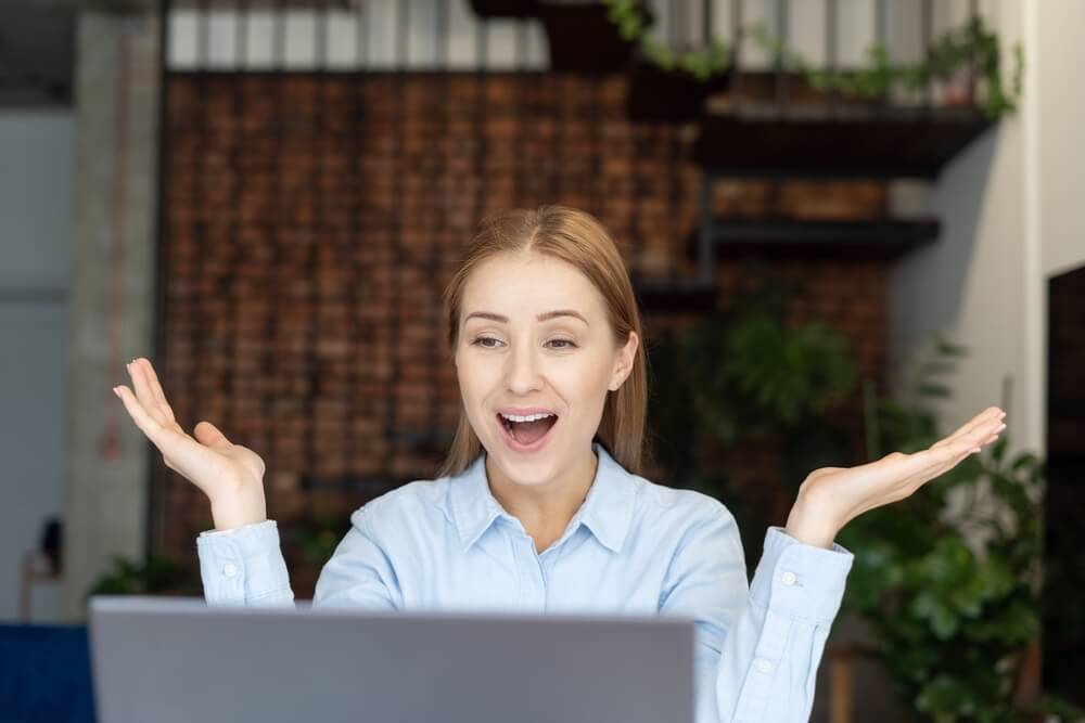 Portrait of Happy Woman Sitting in Front of Laptop. Lady Celebrating Success When Working From Home Office